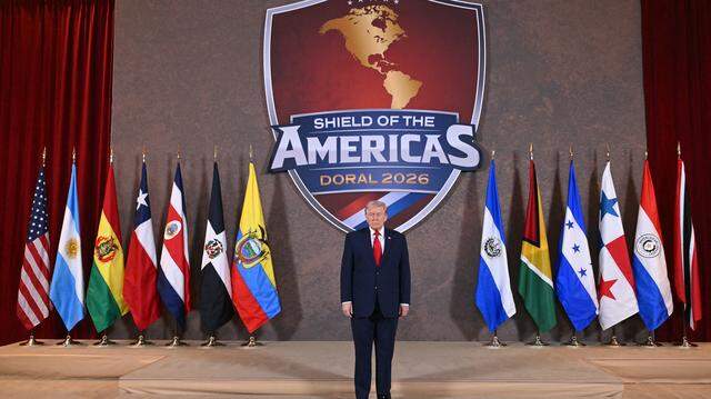 President Donald Trump poses for a photo at the start of the "Shield of the Americas" Summit at Trump National Doral in Miami, Florida, March 7, 2026. President Trump is hosting a dozen right-wing leaders from Latin America and the Caribbean to discuss issues facing the region, from organized crime to illegal immigration. The summit also aims to serve Washington by boosting US interests in the region and curbing those from foreign powers like China. 